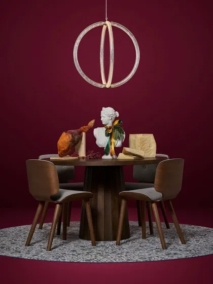 A single Luminora pendant makes a statement over a dining table in this artistic, color-rich setting. Its form is both modern and timeless, fitting into a variety of interior styles.