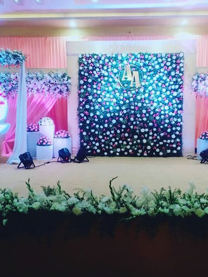 We design the entire stage to complement the naming ceremony's main features. Here, the floral swing is balanced by a custom flower wall and decorative elements, creating a harmonious and grand setting.