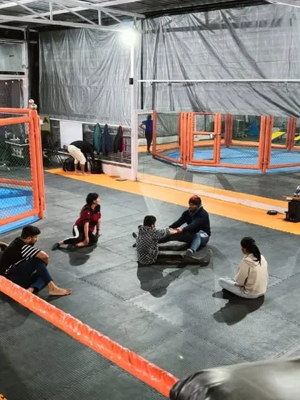 Members cooling down and socializing after a session at our Noida Extension facility. The spacious matted area is perfect for group classes and individual practice.
