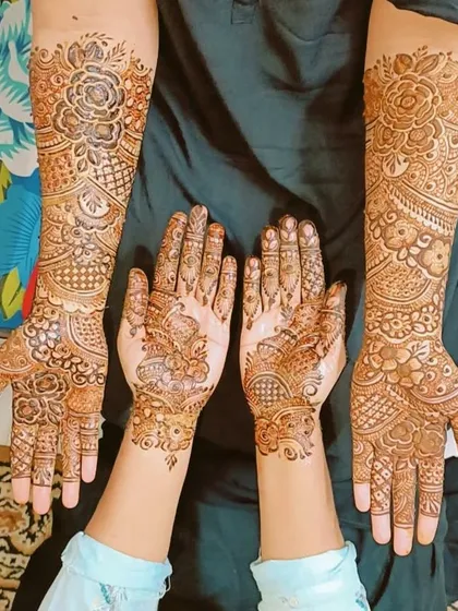 A group photo showing mehndi for the bride and her bridesmaids, with coordinated yet unique designs for each.