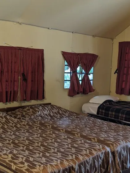 The interior of a tented cottage at Kali Adventure Camp, spacious enough for a small family or group of friends.