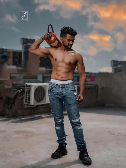Taking the shoot to a Gurgaon rooftop at sunset. This on-location fitness photo combines a gritty, urban environment with a well-defined physique, showing how we can create epic visuals outside the studio.