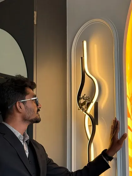 A personal touch. Here I am, admiring the custom-designed, leaf-inspired wall light in a newly finished master bedroom. Getting the lighting right is key to setting the perfect mood.