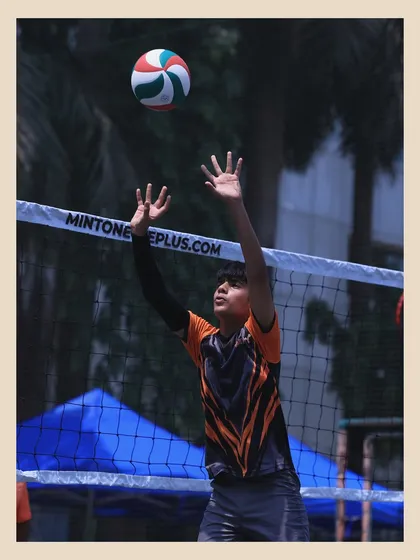 A young setter positions himself under the ball, hands ready to make a play. We train our setters to be the strategic quarterbacks of the court.