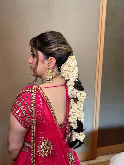 A view of the back, showcasing the beautiful hairstyle with a gajra braid.