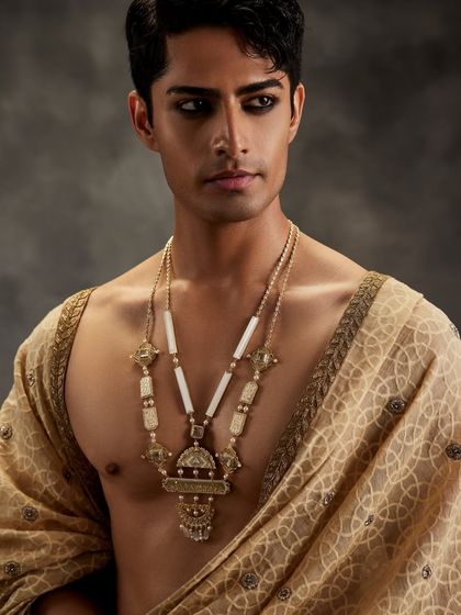 The Amelia Multi-Strand Necklace embodies the essence of the modern man who boldly adorns masterfully crafted ornaments. This piece makes a powerful statement, blending heritage with a contemporary spirit.