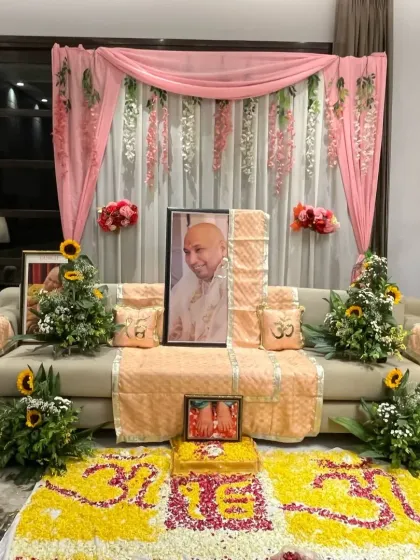 Another view of the beautiful Guruji satsang decor, showing the peaceful and respectful arrangement created for the spiritual gathering.