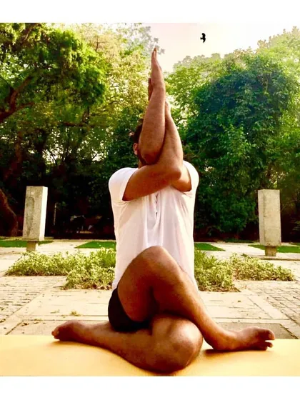 Combining the arm position of Garudasana (Eagle Pose) with the leg position of Gomukhasana (Cow Face Pose) creates a deep stretch for the shoulders and hips simultaneously. It's a powerful posture for releasing tension.