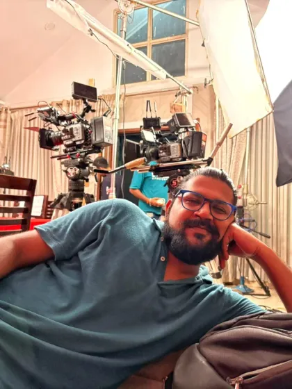 Taking a quick break between takes. Shoots can be long and demanding, but my passion for filmmaking keeps the energy high. In the background, you can see our two-camera setup ready for the next shot.