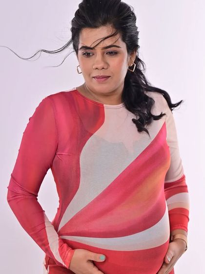 A tender moment, cradling her bump. The makeup is soft and understated, perfectly capturing the gentle and loving mood of the photo.