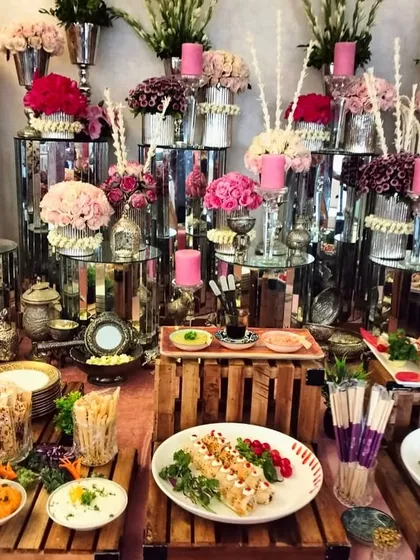 Table settings of our dreams! This lavish spread features a stunning array of pink florals, silverware, and our most popular appetizers, creating a truly opulent atmosphere.