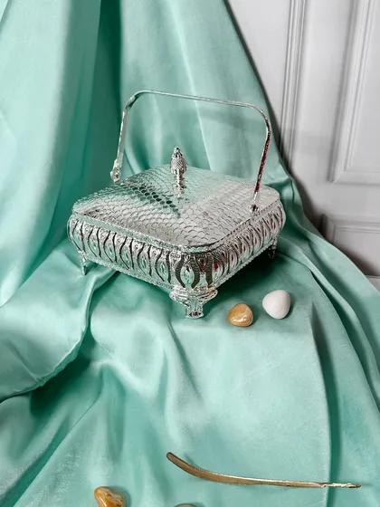 A slightly different angle of the square silver basket, highlighting its sturdy handle and detailed craftsmanship. A perfect blend of traditional design and modern utility.