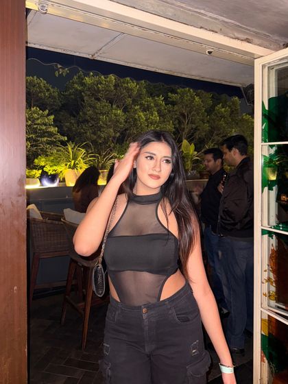 A confident pose, looking away from the camera.