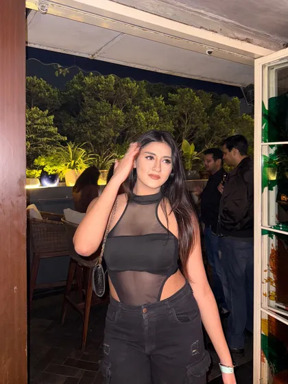A confident pose, looking away from the camera.
