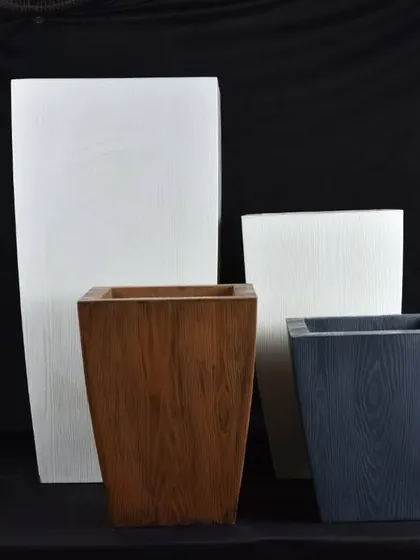 A collection of square and rectangular planters with a wood-grain finish. These fiber pots give the look of wood without the weight or risk of rotting.