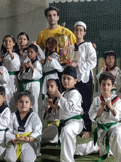 This is what our community is all about: celebrating success together. Posing with a trophy after a tournament, these students show the pride and teamwork we build in every class. We are a team of champions.