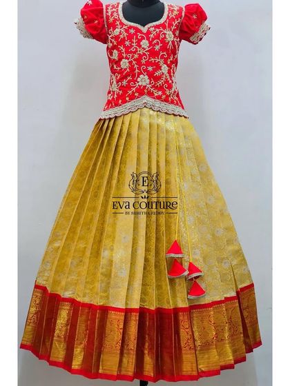 A beautiful red and gold combination. The blouse is heavily embroidered, and the skirt is a subtle gold brocade with a red Kanchi border.