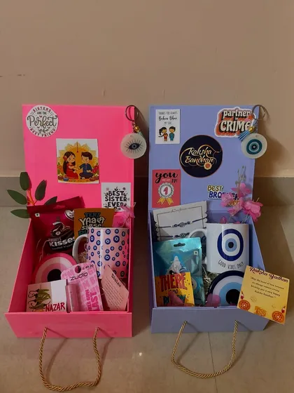 A side-by-side view of the pink and blue Rakhi hampers. They are designed to be a perfect pair, just like the siblings they are for.