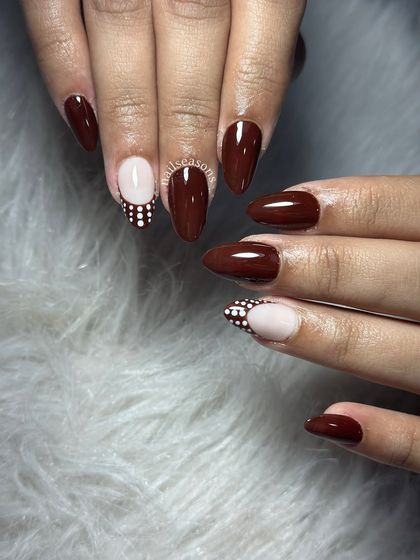 Choco glam with a pop of polka dots. A rich brown polish paired with a nude accent nail featuring a fun dot pattern.