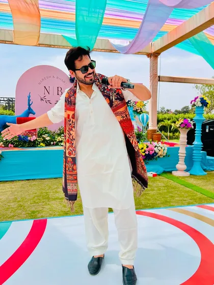 On stage, mic in hand, ready to bring the heat. This is me in my element at a vibrant Mehendi carnival, making sure the energy is high and the smiles are wide.