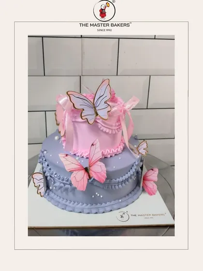 A two-tiered cake that brings a touch of whimsy to any party. With delicate lavender and pink frosting, intricate piping, and beautiful butterfly accents, this design is a favorite for birthdays and baby showers.