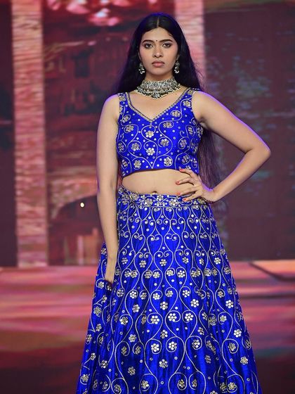 Another runway shot, demonstrating how the makeup looks under different stage lighting, remaining consistent and impactful.