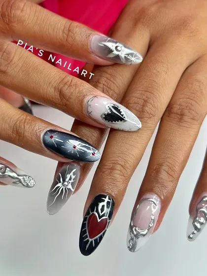 For my clients who love a darker, edgier vibe. This gothic-inspired set features a mix of airbrushed aura effects, intricate chrome detailing, and hand-painted hearts and spiders. It’s bold, it’s unique, and it’s totally obsessed.