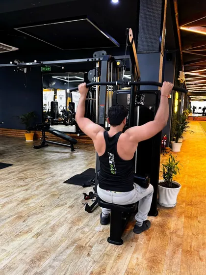 Performing a lat pulldown, a key exercise for building a wide and strong back.