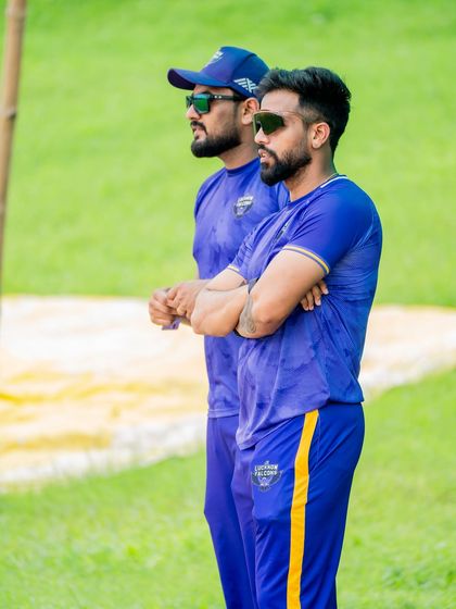 Game faces on. Watching the game intently from the sidelines, analyzing player movements and readiness. It's about staying focused and anticipating the team's needs.