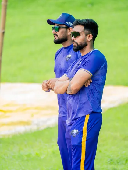 Game faces on. Watching the game intently from the sidelines, analyzing player movements and readiness. It's about staying focused and anticipating the team's needs.
