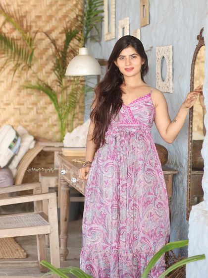 A collection of relaxed, bohemian-style portraits taken at a rustic cafe. The model is featured in a flowing paisley dress, interacting with props like a guitar, creating a natural and artistic vibe.