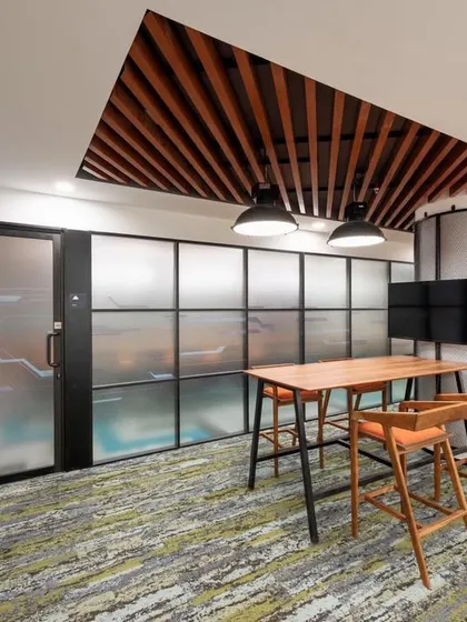 A collaboration space located just outside a boardroom, serving as a spill-out area for pre or post-meeting discussions.