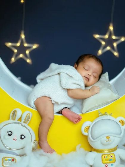 A slightly different composition of the 'Blue Moon' theme, capturing the full crescent moon and the sleeping baby. These themed shoots are a wonderful way to celebrate your new arrival.