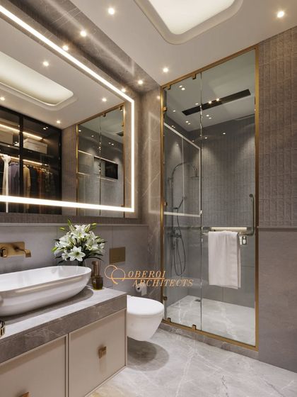 This bathroom design features a large backlit mirror that provides excellent lighting for grooming. The walk-in closet is reflected in the mirror, showcasing the integrated design.