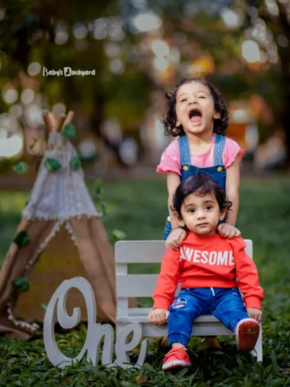 A big sister's joyful shout and a little brother's cool expression perfectly capture their different personalities. This outdoor sibling photoshoot is full of life and fun.