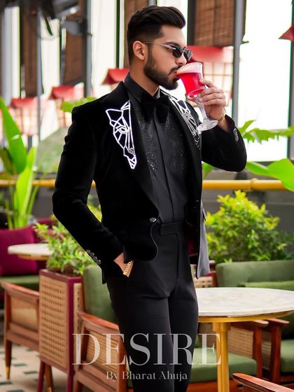 A moment of relaxation in the black velvet blazer. The intricate embroidery and bow tie create a look of pure, sophisticated elegance.