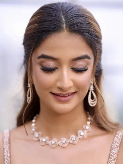 A close-up of the rhinestone-accented eye makeup. It’s a modern, elegant touch for a special occasion.