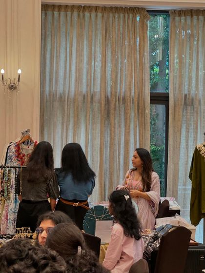 An intimate shopping moment where a vendor provides personalized attention to her customers.