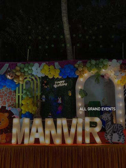 Another full view of the Manvir's jungle party stage, showing the colorful balloon arch and variety of animal props.