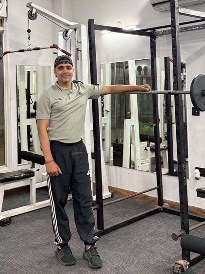 Leaning on the squat rack.