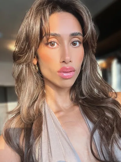 The best result is a happy client who feels amazing in their new hair. This photo captures the confidence that comes from a professional hair extension service, featuring beautiful, bouncy layers and a flawless color blend.