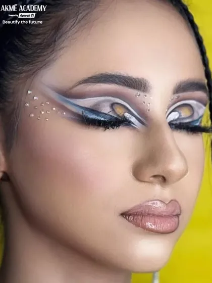 Another angle of the creative graphic eye makeup, showing how the design complements the model's eye shape. We teach students to customize artistic looks for every individual.