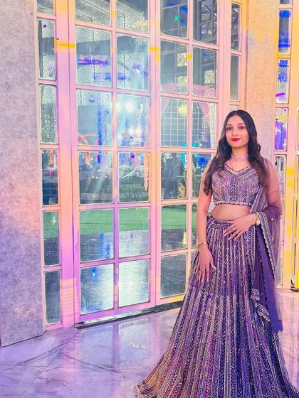 The same purple rental lehenga seen at a wedding function. The color stands out beautifully, making it a great choice for memorable photos.