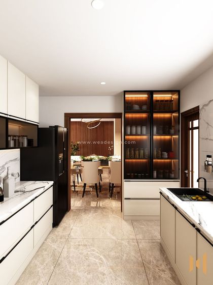 A view from the end of the galley kitchen, showing the illuminated glass crockery unit and the open doorway to the dining area.