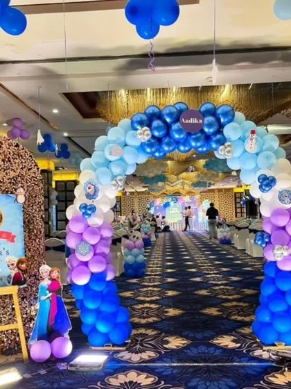 A grand entrance arch for a Frozen-themed birthday party in a banquet hall, setting a magical tone from the moment guests arrive.