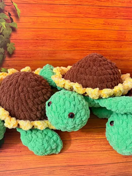 These cuddly tortoises are made with an ultra-soft, velvety plush yarn that's perfect for hugs. This group shows my sunflower-themed design, featuring a cheerful green body and a shell that looks just like a blooming sunflower.