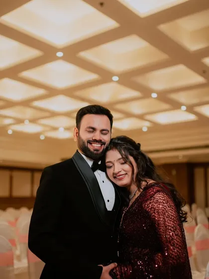 A sweet and happy moment. The bride's soft, curly hairstyle and glowing makeup create a romantic and modern reception look.