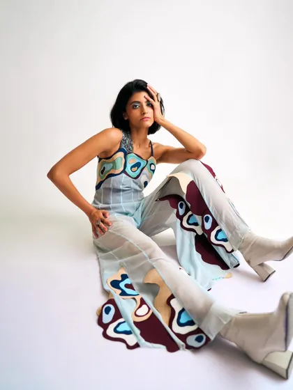 This look from a contemporary designer's shoot features a sheer, printed co-ord set. I styled it with chunky white boots to ground the whimsical, 60s-inspired pop-art print and create a modern, playful look.