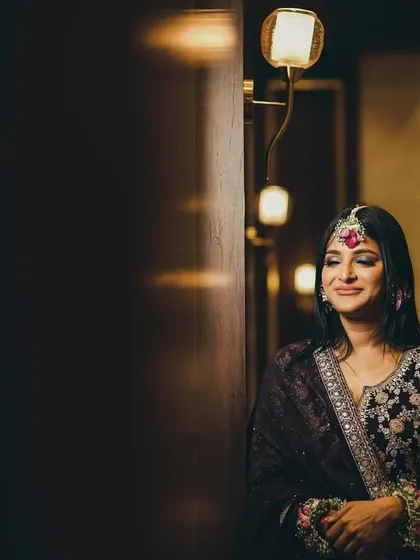 A serene portrait of the bride, her eyes closed in a moment of quiet contemplation. The warm, soft lighting creates an intimate and peaceful mood.