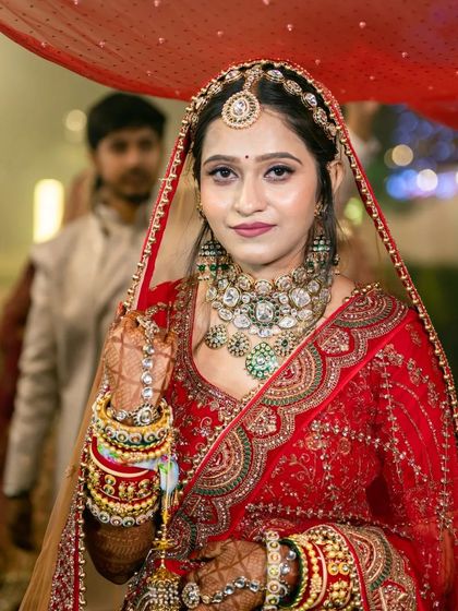 The bride's grand entrance, a classic shot capturing her beauty and the richness of her traditional red bridal attire.